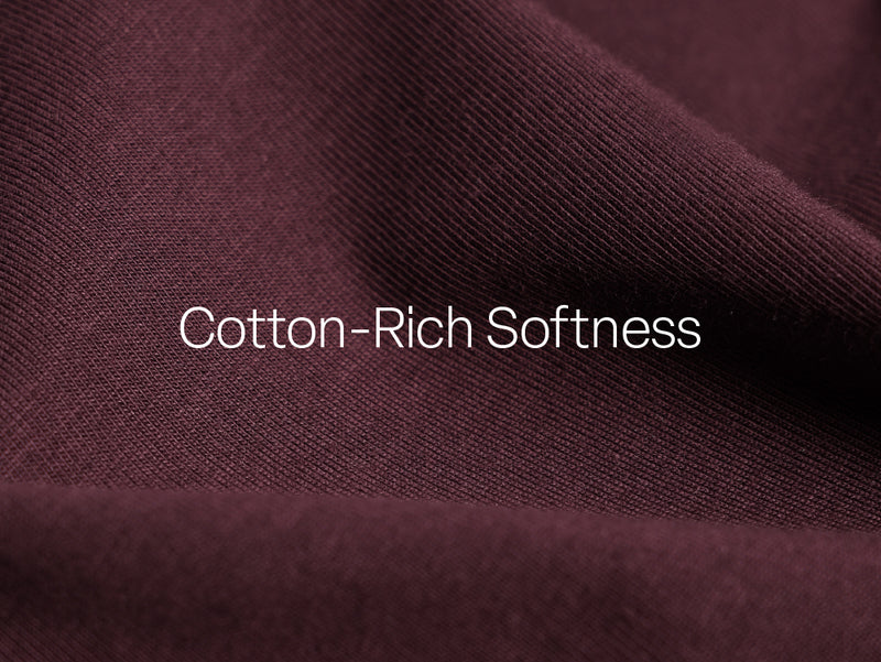 Close-up of a textured purple fabric with 'Cotton-Rich Softness' text overlay.